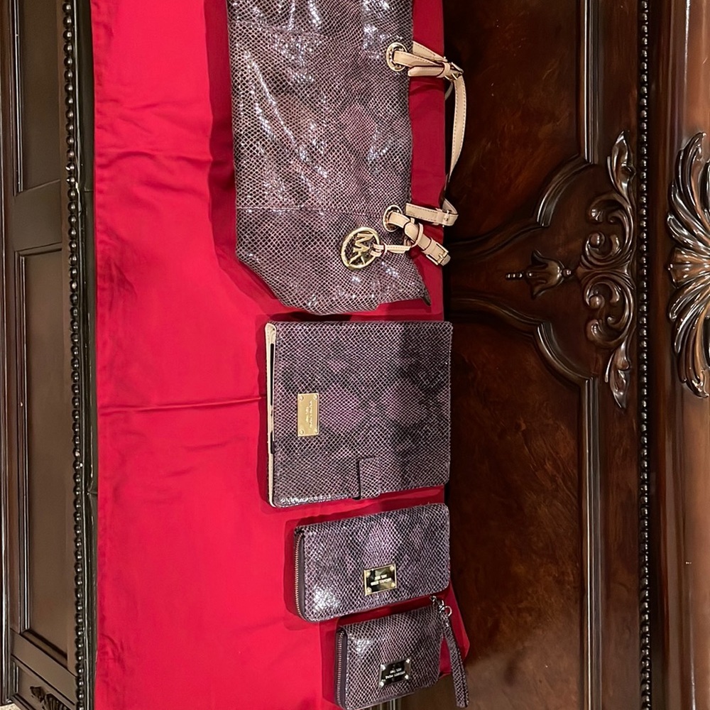 4 piece Michael Kors gently used pocket book, IPad case, checkbook  & wallet.